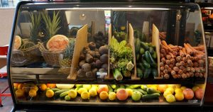 Bar display of fruits and vegetables that could be used in juices.