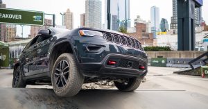 Jeep Cherokee driving through a New York City street.