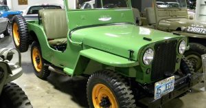 A green 1945 Willys CJ 2A in a museum.